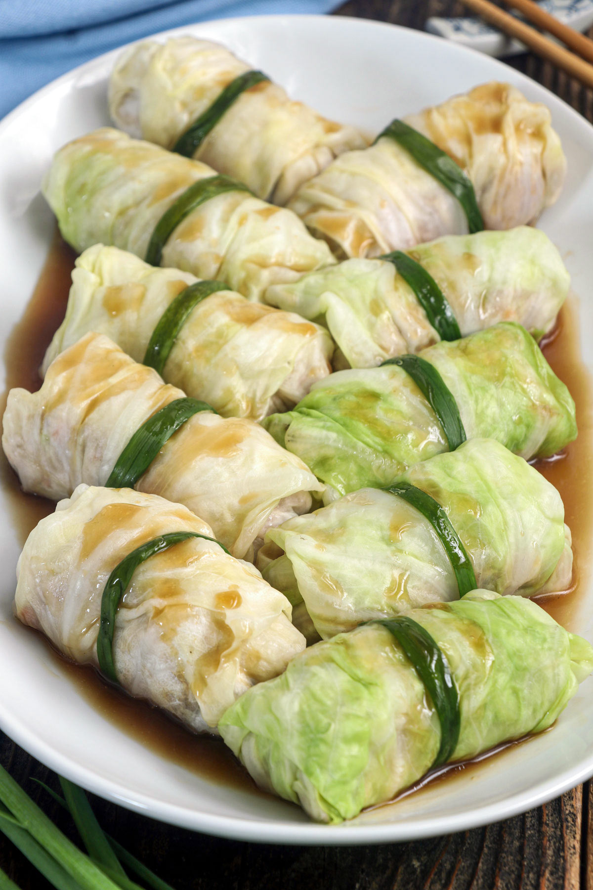 Asian stuffed cabbage rolls on a serving plate.