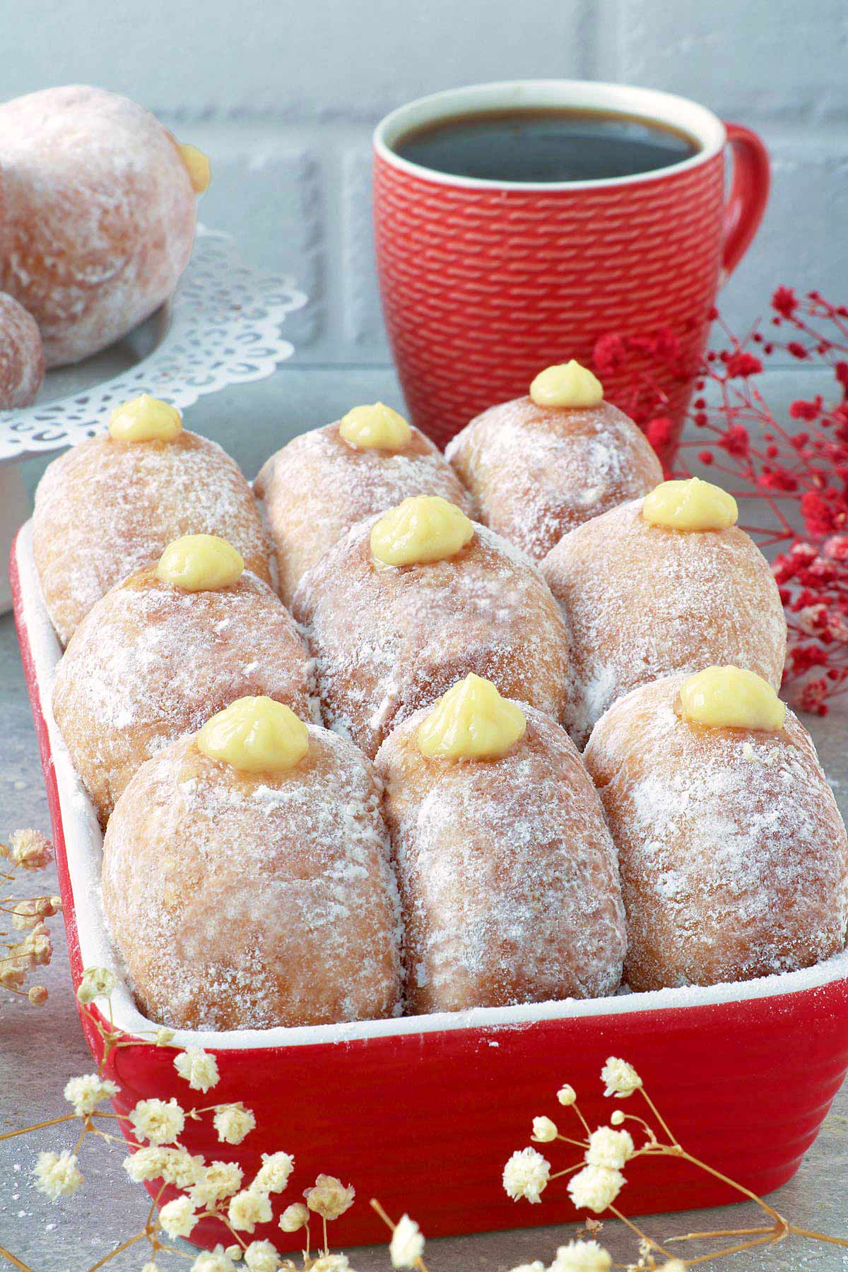 Donuts filled with bavarian cream on a box.