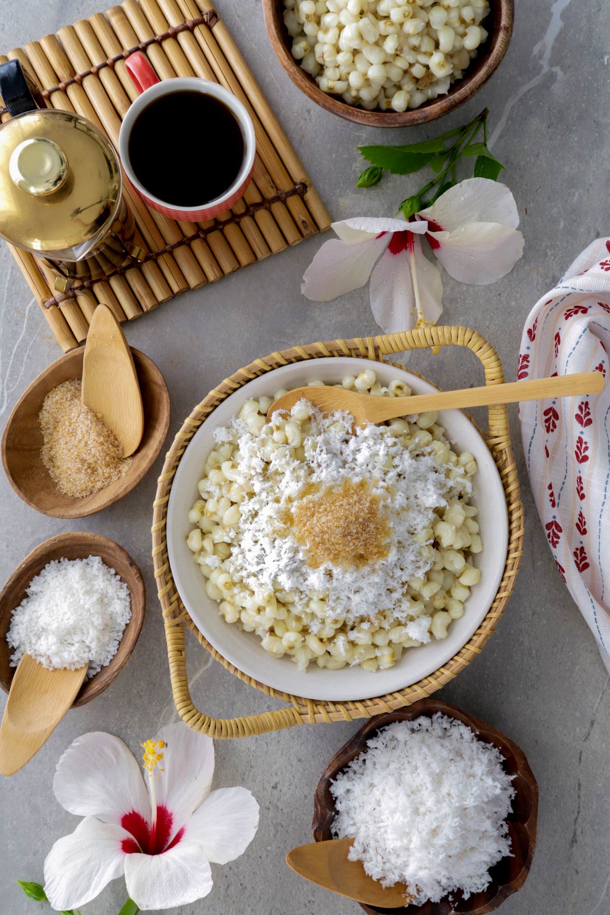 Binatog on a serving platter served with grated coconut, sugar, and coffee.