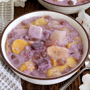 Binignit in a serving bowl with ube, taro, cassava, banana, langka, sago and glutinous rice.