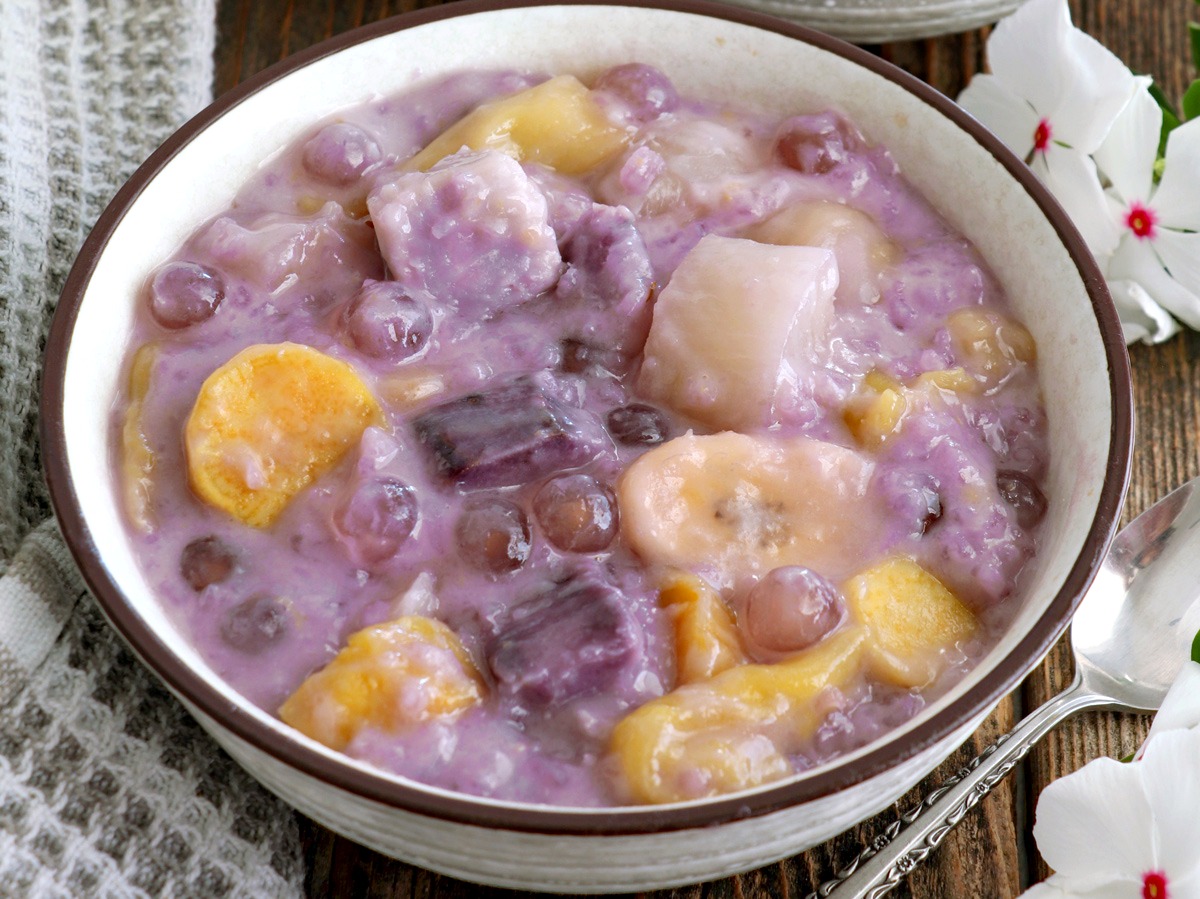 Binignit in a serving bowl with ube, taro, cassava, banana, langka, sago and glutinous rice.