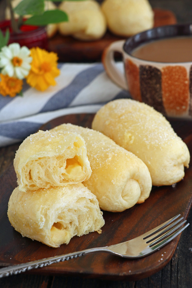 Super soft, sweet rolls with cheese filling coated with butter and sugar.