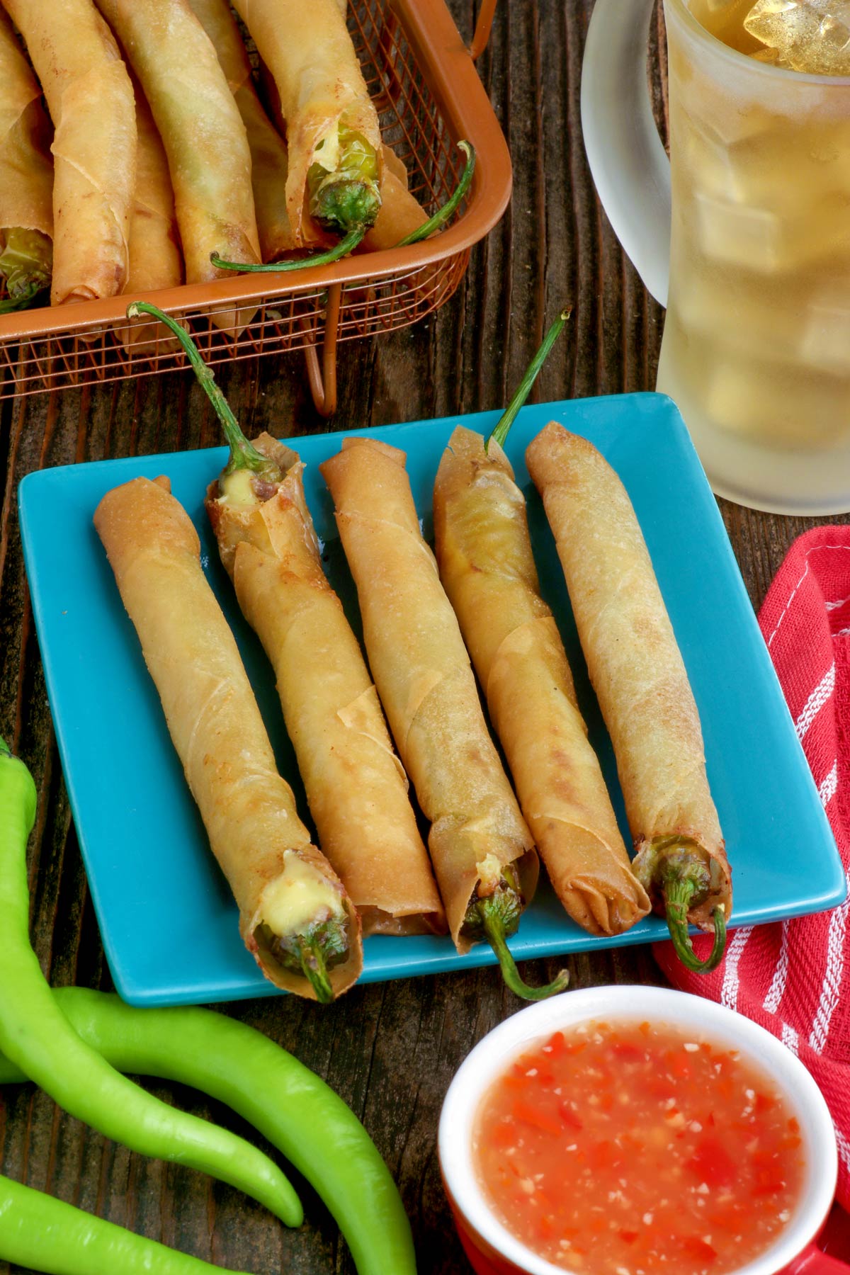 Freshly cooked Dynamite Lumpia on a serving plate made with green chilis and cheese wrapped with spring roll wrappers.