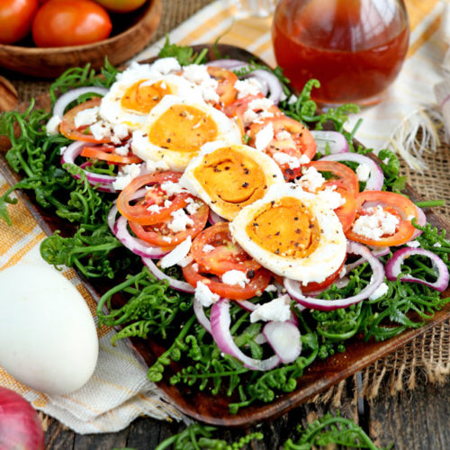 Fiddlehead Fern Salad with tomatoes, onions, salted egg and sweet vinegar dressing.