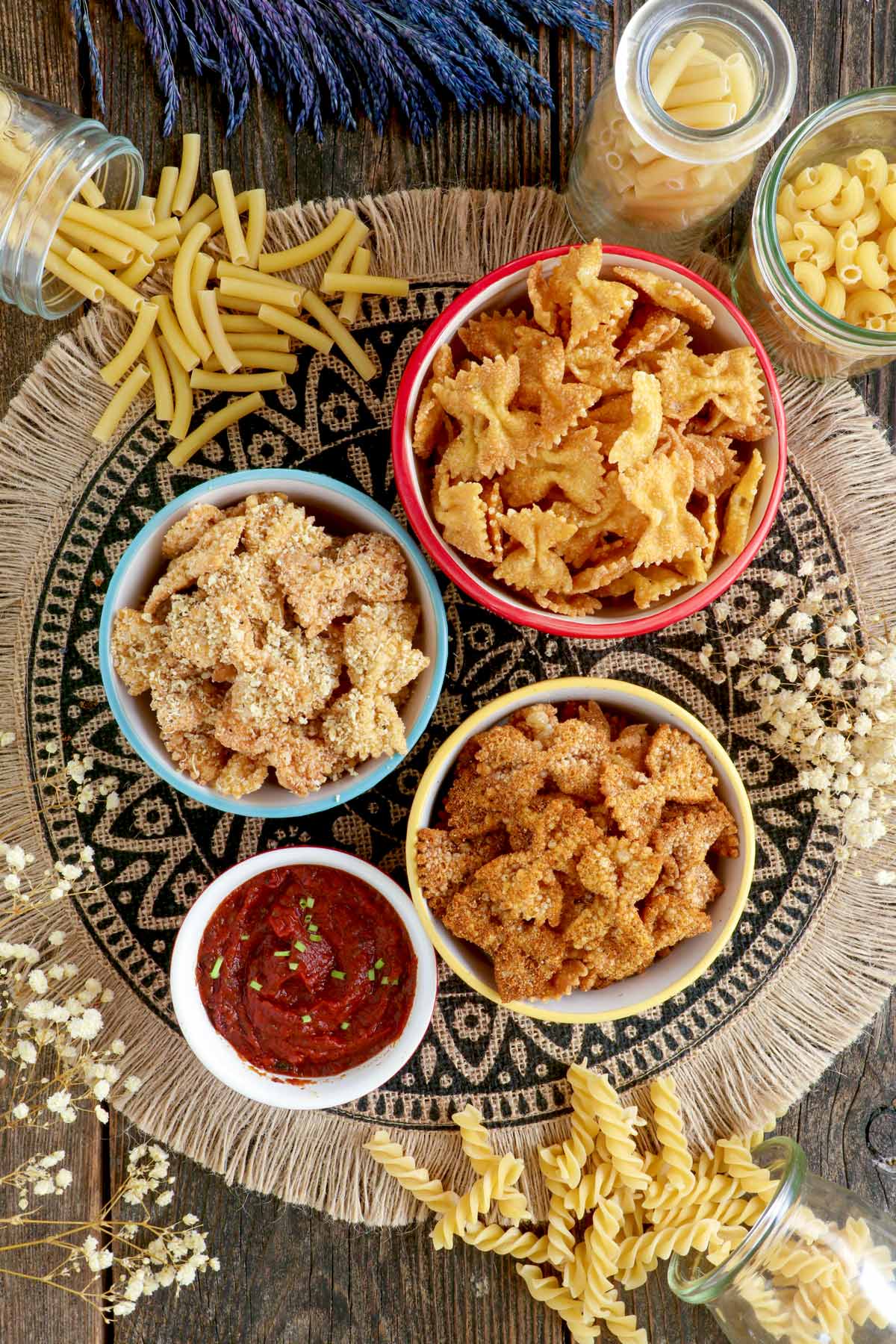 Fried pasta chips in a serving bowls with homemade marinara sauce.