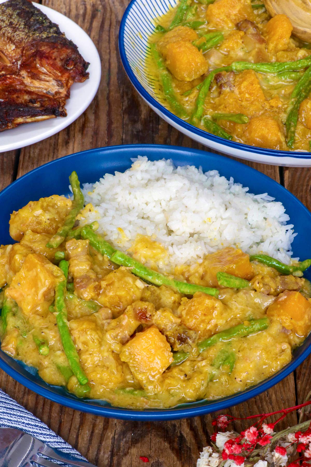 Ginataang Kalabasa with Sitaw in a plate with steamed rice.