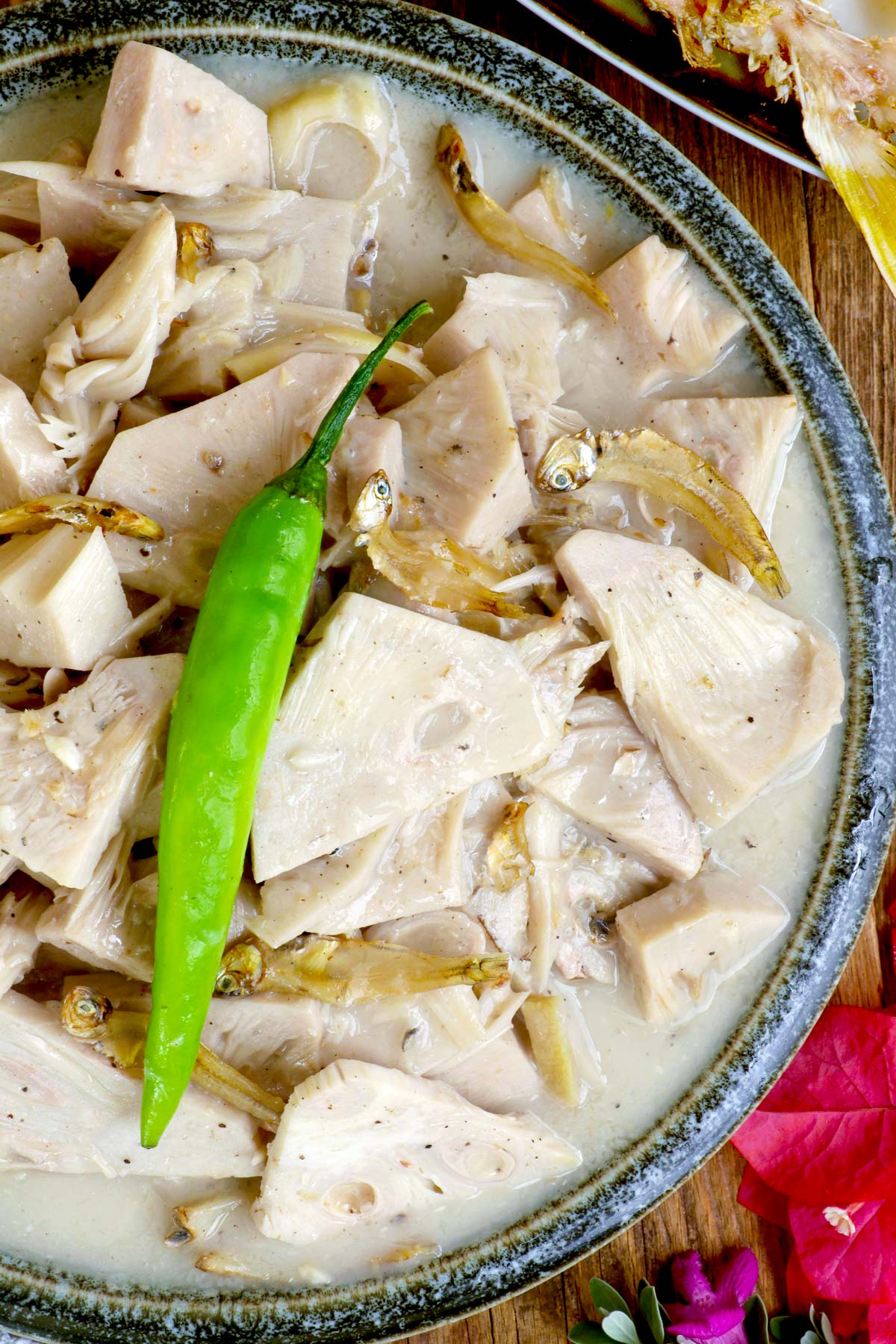 Ginataang Langka in a serving bowl topped with green chili.