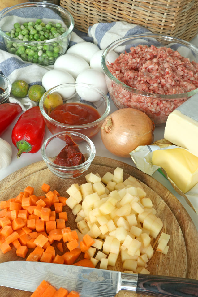 Filipino ground pork recipe cooked in tomato sauce with medley of carrots, potatoes, green peas and more