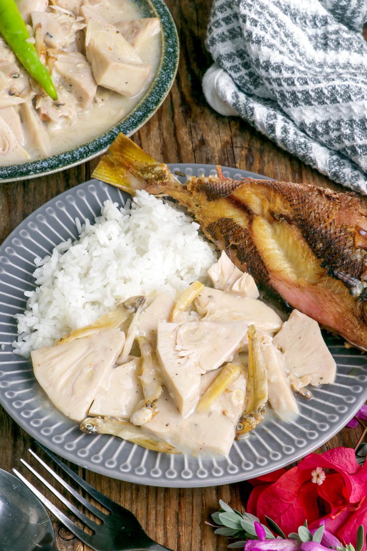 Ginataang Langka on a plate with steamed rice and fried fish.