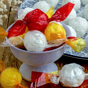 Macapuno Balls made from macapuno preserves and condensed milk wrapped in colorful cellophane plastics.