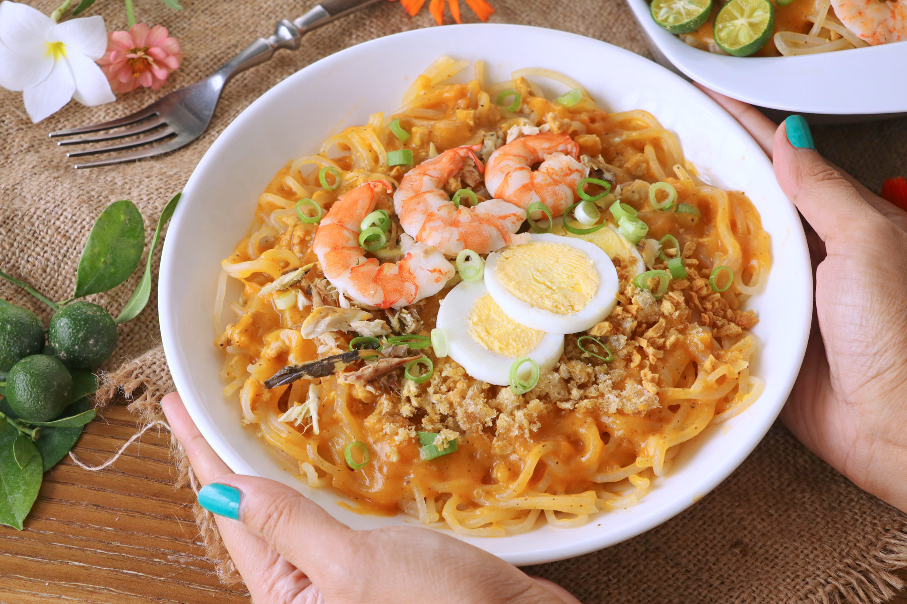 Rice noodle with savory yellow-orange sauce, shrimp and eggs