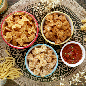 Pasta chips in a serving bowls with homemade marinara sauce.