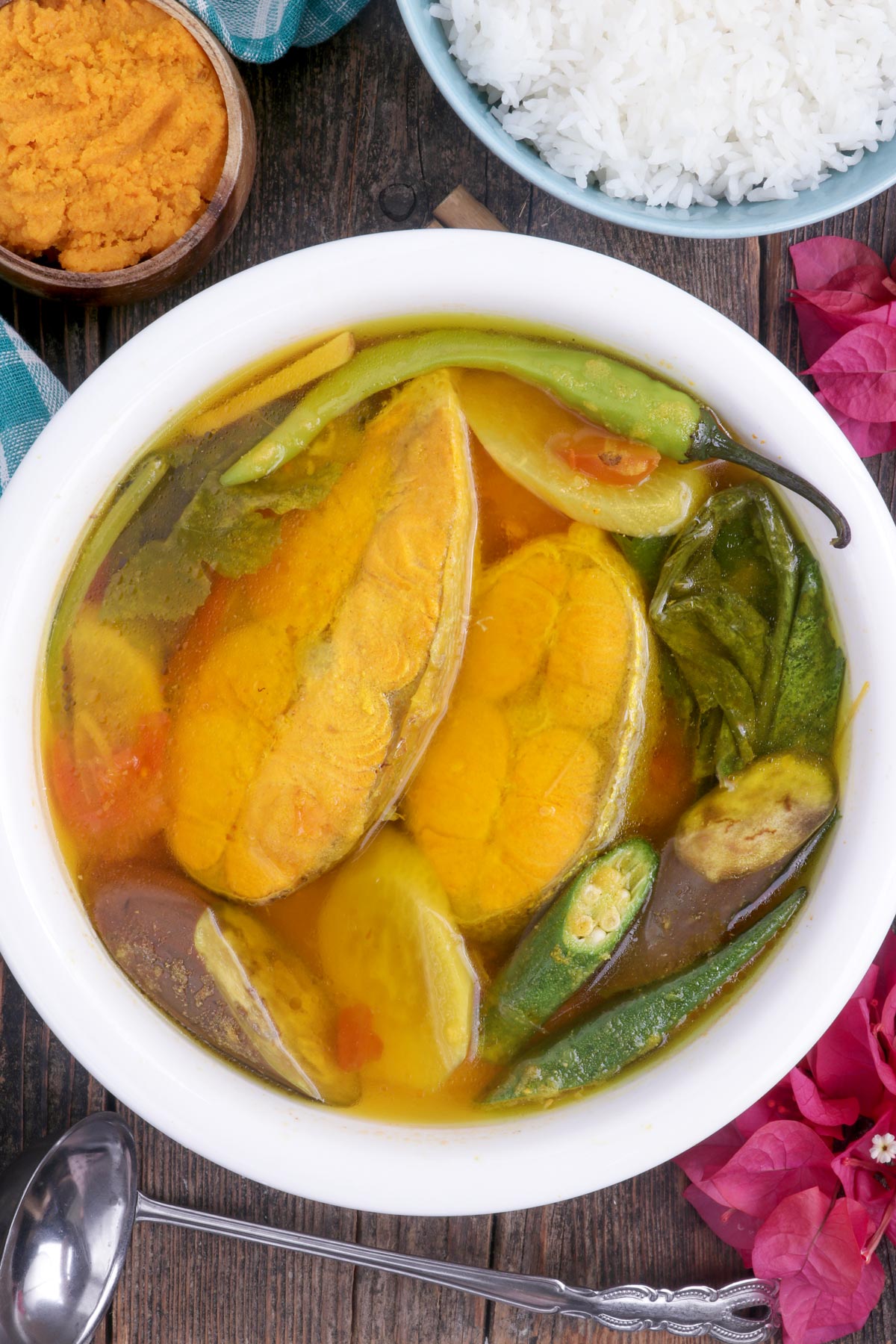 Sinigang sa Miso in a serving bowl made with salmon fillets, fresh veggies and made extra flavorful with miso paste.