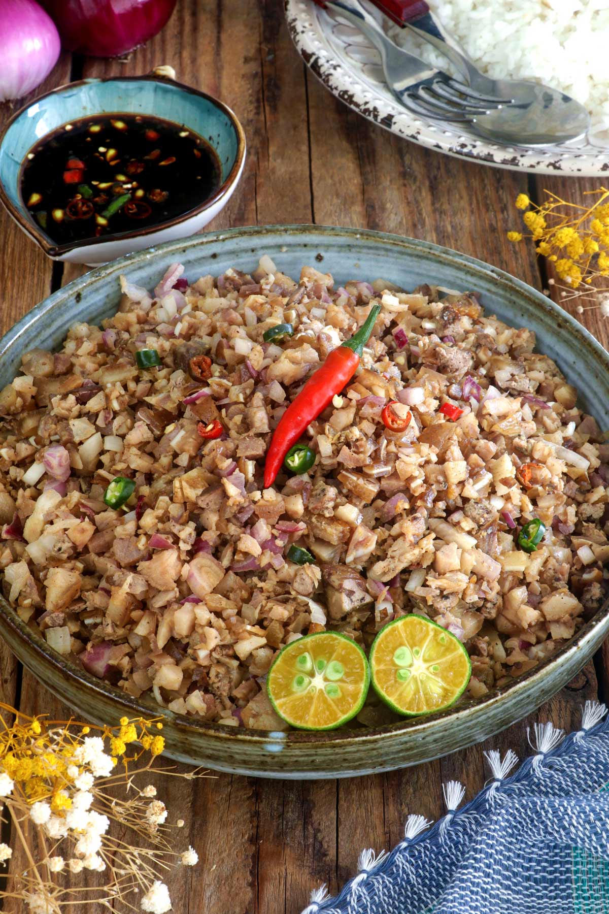 Autthentic Sisig made from pork ears and cheeks, chicken liver, onion, and chili pepper flavored with soy sauce and calamansi juice.